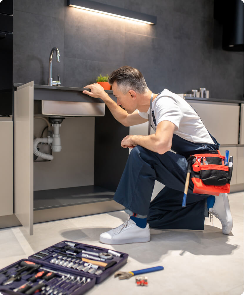 Plumber inspecting kitchen waste